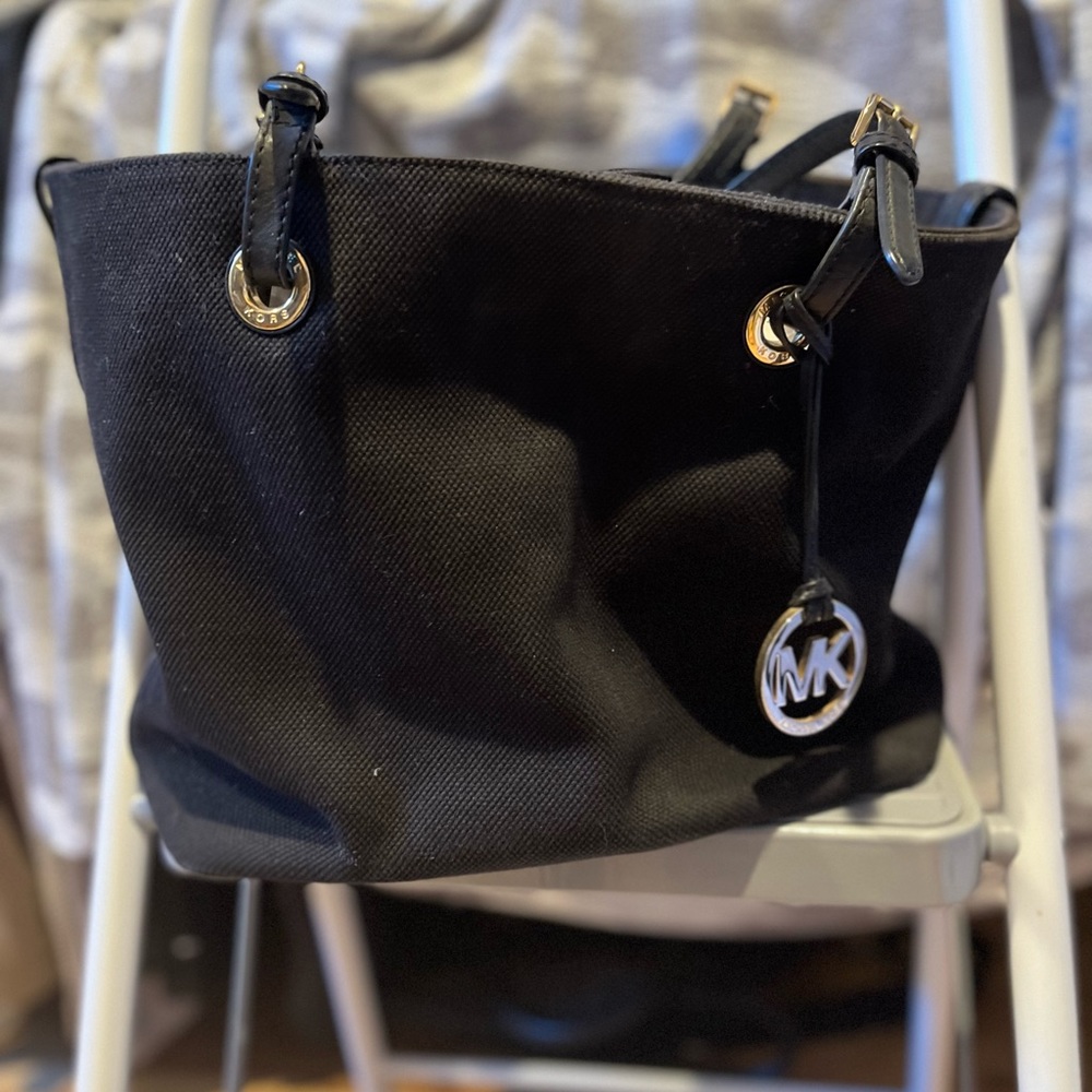 This is a black cloth micheal kors bag